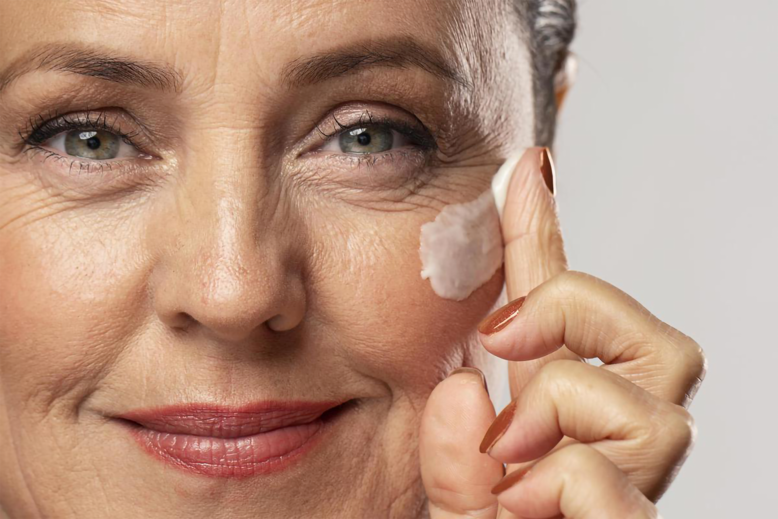 older-woman-using-moisturizer-her-face